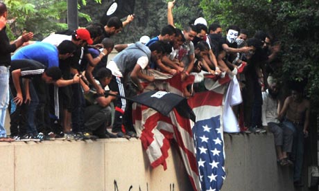Egyptian protesters tear down the US fla