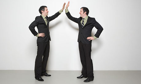 Businessmen high five each other 