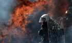 A firebomb explodes near riot police in Athens