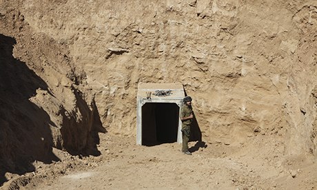 An Israeli soldier stands by the opening of a tunnel the IDF claims was built by terrorists. 