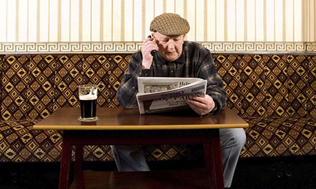 Old man reading in the pub