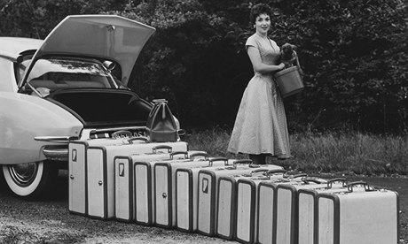 Gina Lollobrigida beside a long row of suitcases and the boot of a Citroen DS 19