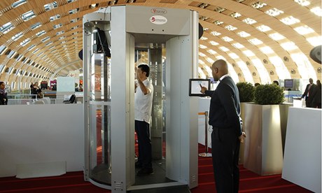 A man inside a full-body scanner being trialled at Charles-de-Gaulle airport