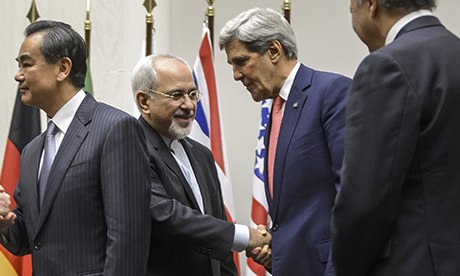 Javad Zarif shakes hands with John Kerry