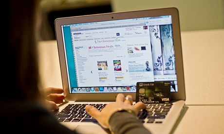 Woman using laptop to buy from Amazon