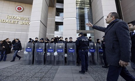 Riot police stand guard in front of the courthouse in Istanbul