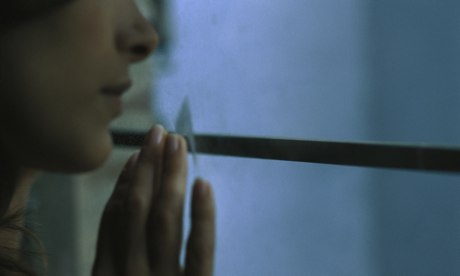 Woman looking out of window, close-up, cropped