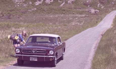 Hiker Meat: American-style car apparently picking up a female hitchhiker on isolated road