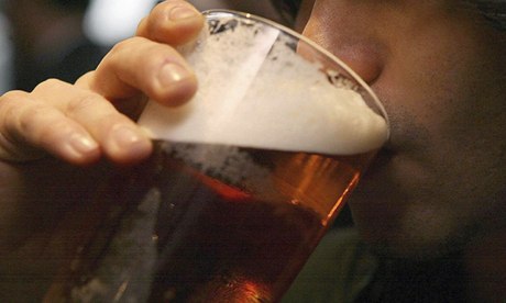 someone drinking pint of beer