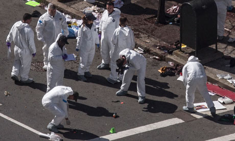Investigators survey the site of a bomb blast 