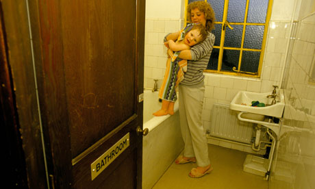 A homeless mother in a hostel bathroom