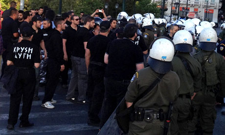 Police confront Golden Dawn party members at a food giveaway in Athens