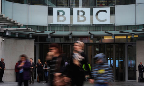 Pedestrians walk by the BBC's Broadcasting House building