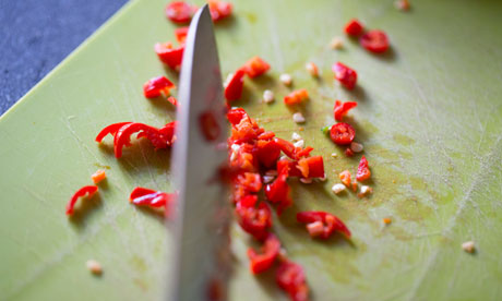 Chilli being cut on a chopping board