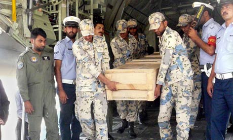 Pakistani air force officers carry a coffin