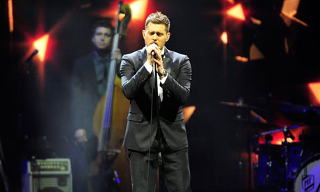 Michael Bublé on stage at the O2 Arena, London, bassist in background