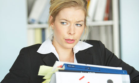 Young woman carrying document files in the office