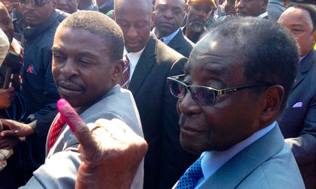 Robert Mugabe shows his finger after casting his vote during presidential elections in Harare, Zimbabwe, on Wednesday. Photograph: Meng Chenguang/Rex Features