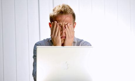 Frustrated man in front of laptop 