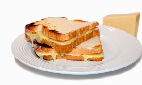 Toasted Cheddar Cheese sandwich with the liquified cheese oozing out from between the bread