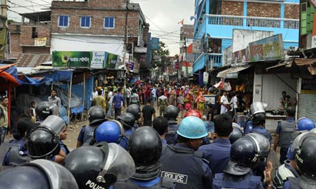 Bangladeshi police block the road in front of protesting garments workers