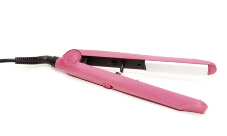 An electric pink hair straightener.