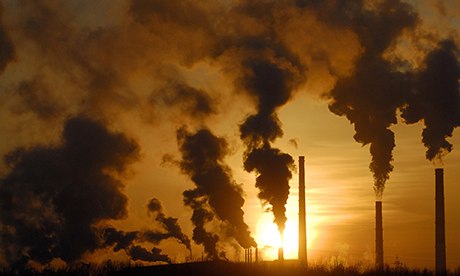 Smoke rises from chimneys of a factory during sunset in the Siberian town of Achinsk