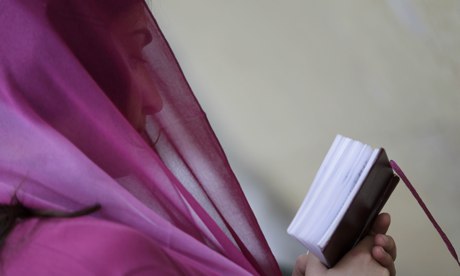 A woman reads a prayer book during a religious service at Sioni Cathedral in Tbilisi