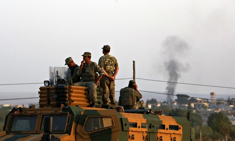 Turkish soldiers watch mortar shell smoke rises Kobani