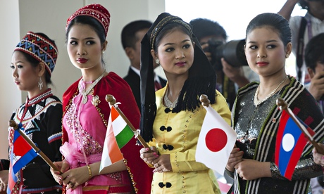 Burmese women dressed in traditional costume greet the heads of state