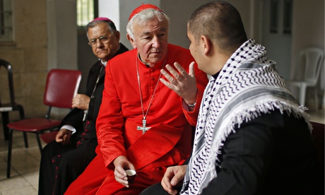 Vincent Nichols, the archbishop of Westminster, meets a priest at Der Latin church in Gaza City.