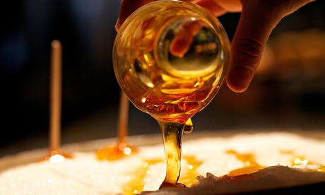 Pouring maple syrup from a glass