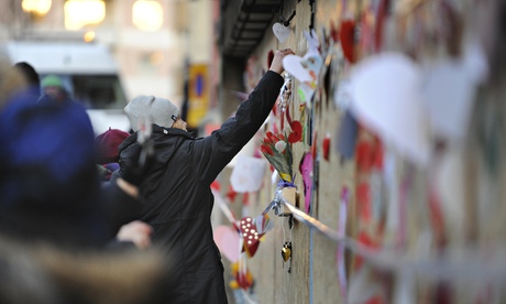 People place flowers and cards outside a mosque after a fire in Eskilstuna, Sweden