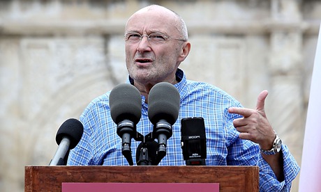 Phil Collins in front of a microphone