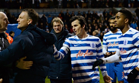 Joey Barton, centre, plays peacemaker as feelings run high following QPR's 2-1 Premier League defeat