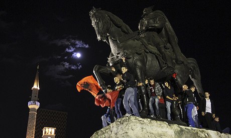 Albanians celebrate on a monument to national hero Skanderbeg after Edi Rama rejected the US request
