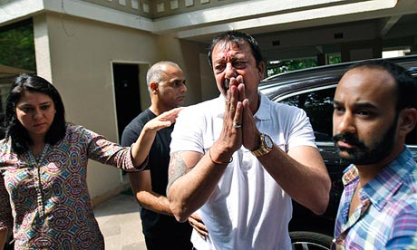 Bollywood actor Sanjay Dutt after breaking down at a press conference, with sister Priya Dutt, left