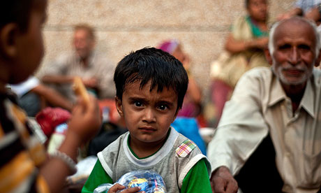 An Indian boy rescued from flood-hit Uttarakhand waits before going to Dehradun relief camps