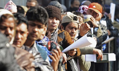Nepalese migrant workers queue in Kathmandu for documents to leave Nepal.