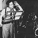 Orson Welles recording the famous 1938 radio drama based on HG Wells's War of the Worlds