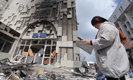 A woman walks by the burnt out