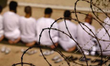 A group of detainees kneels during prayers at Guantanamo Bay