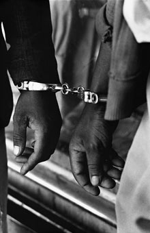 Handcuffed blacks were arrested for being in white area illegally by Ernest Cole