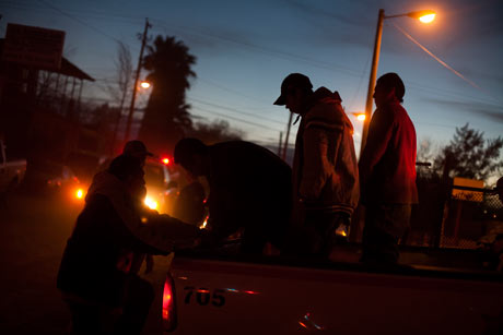 Men arrested by the police are prepared for processing at a small jail in Nogales, Sonora