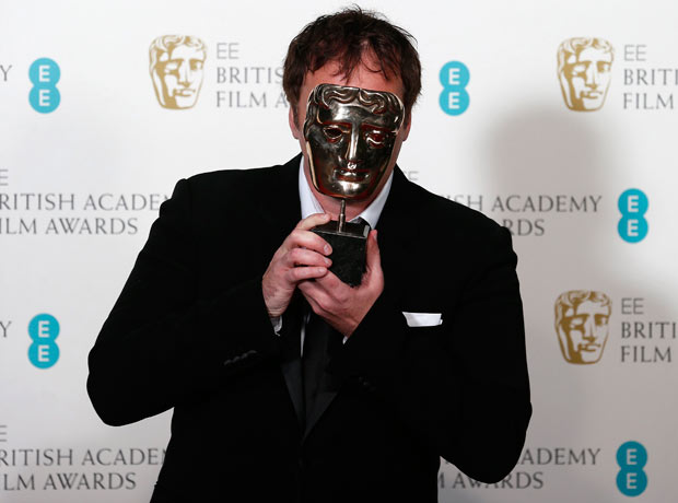 Django Unchained writer/director Quentin Tarantino holds his Bafta for best original screenplay