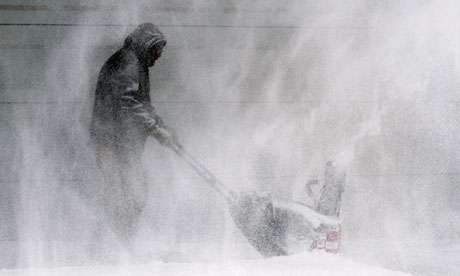 A man clears snow from a house in Wichita, Kansas