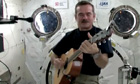 Astronaut Chris Hadfield playing the guitar in a spacecraft