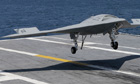 US lands drone on aircraft carrier at sea - video
