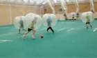 Cricketers play football wearing giant bubbles