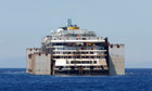 Tugboats drag the Costa Concordia